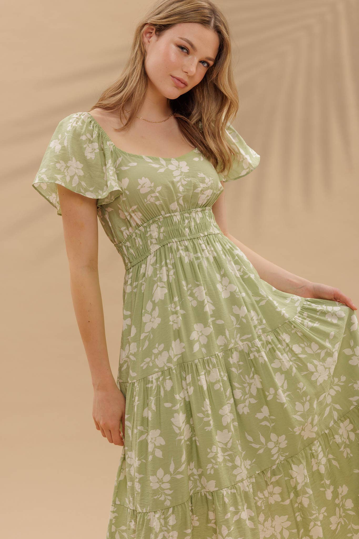 Light green midi dress with a floral pattern and short sleeves