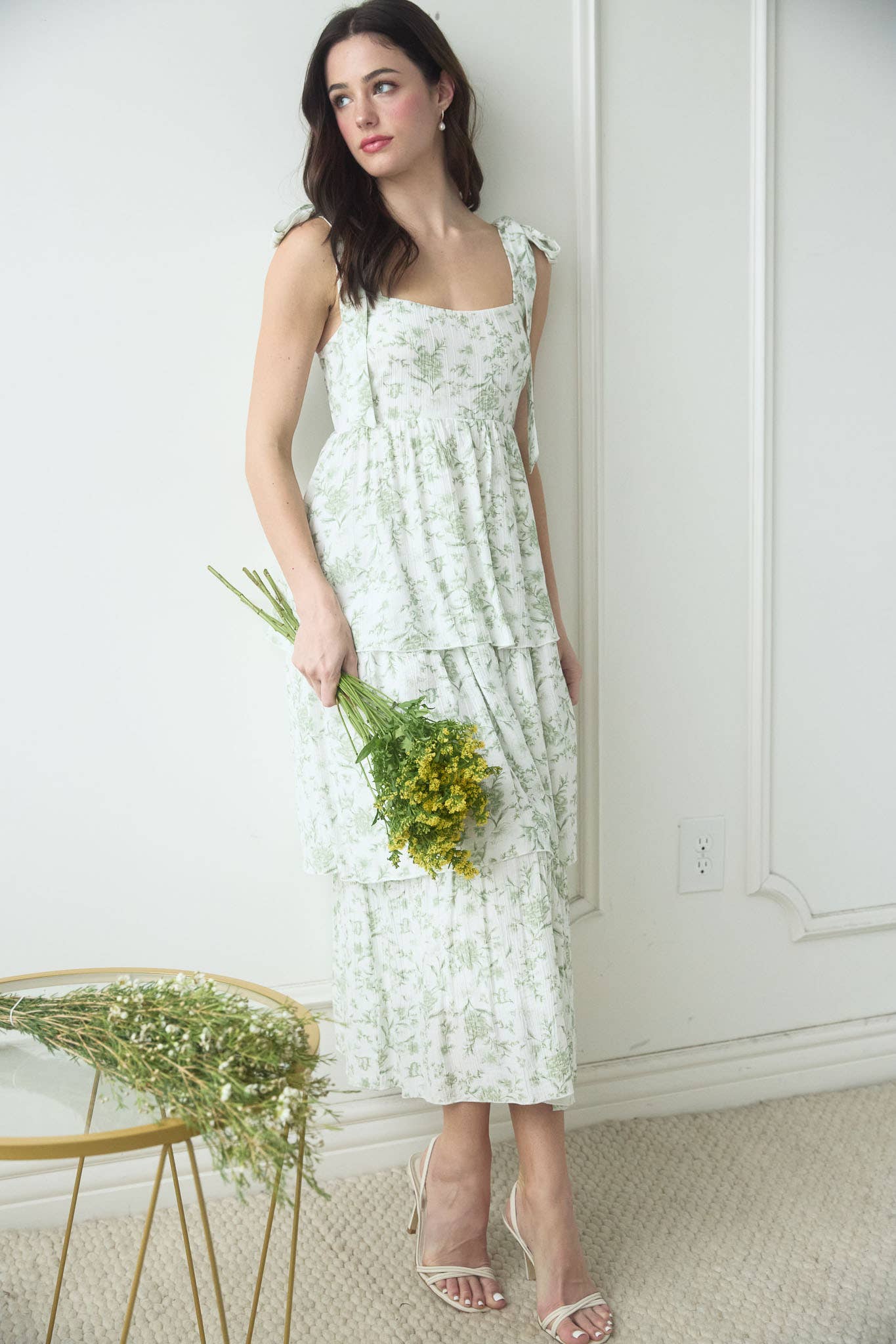White ruffled dress with sage green design, thick straps.